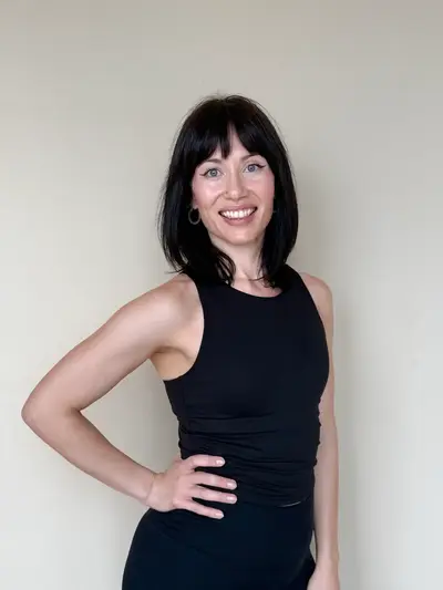 Julia Green, certified Pilates instructor at Revival Pilates Studio, demonstrating posture alignment and core-strengthening exercise with poise.