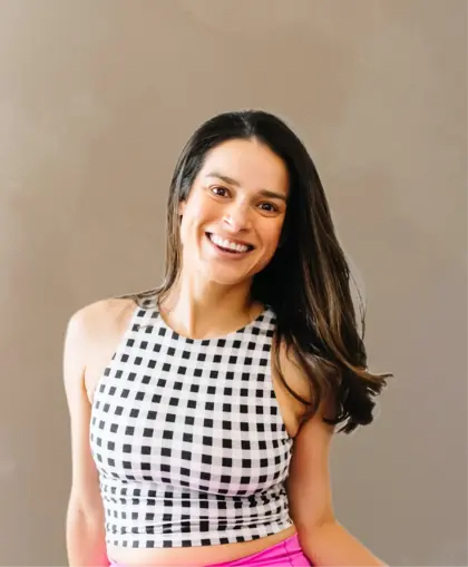 Martha Villanueva, Pilates instructor at Revival Pilates Studio, smiling and teaching with focus on posture and strength